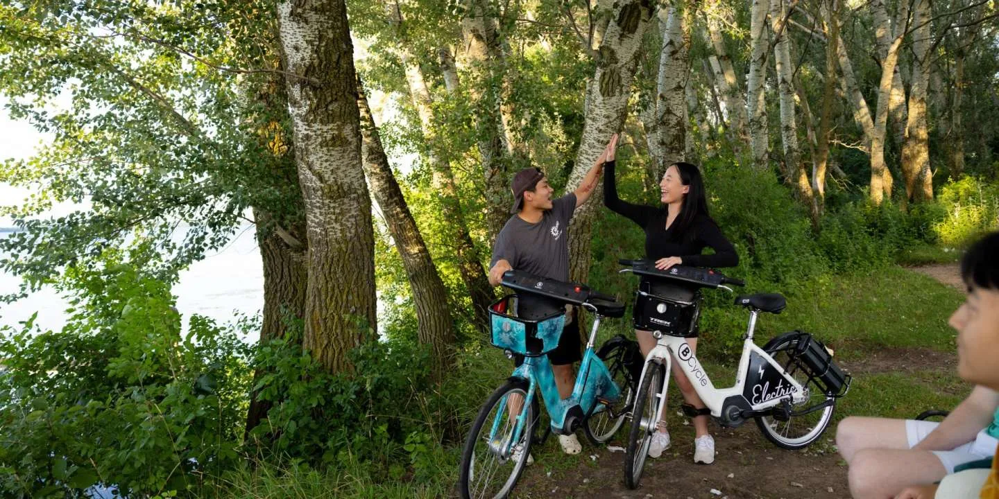 couple giving each other high fives after riding their bike share bicycles