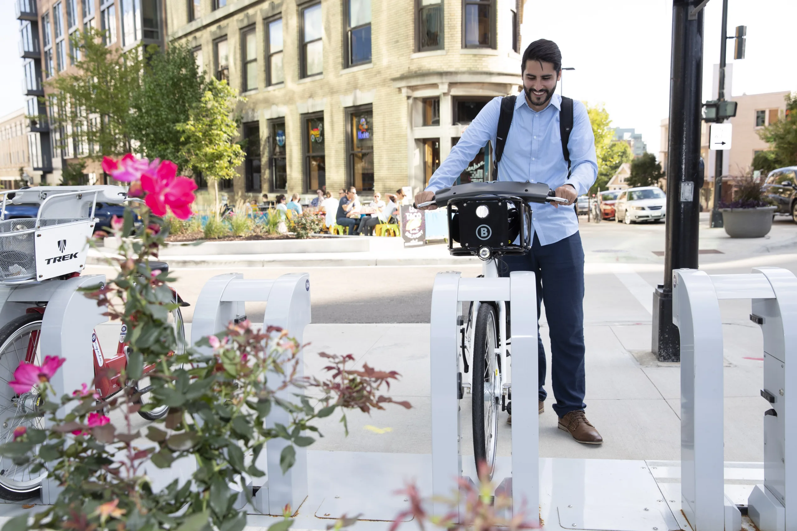 Man removing a bike share dock from a bcycle station